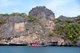 Thailand: Ko Tarutao Marine National Park, fishing boat beneath the cliffs of an island close to Ko Tarutao